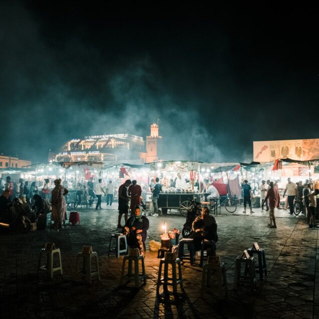 people standing on a beach during night time
